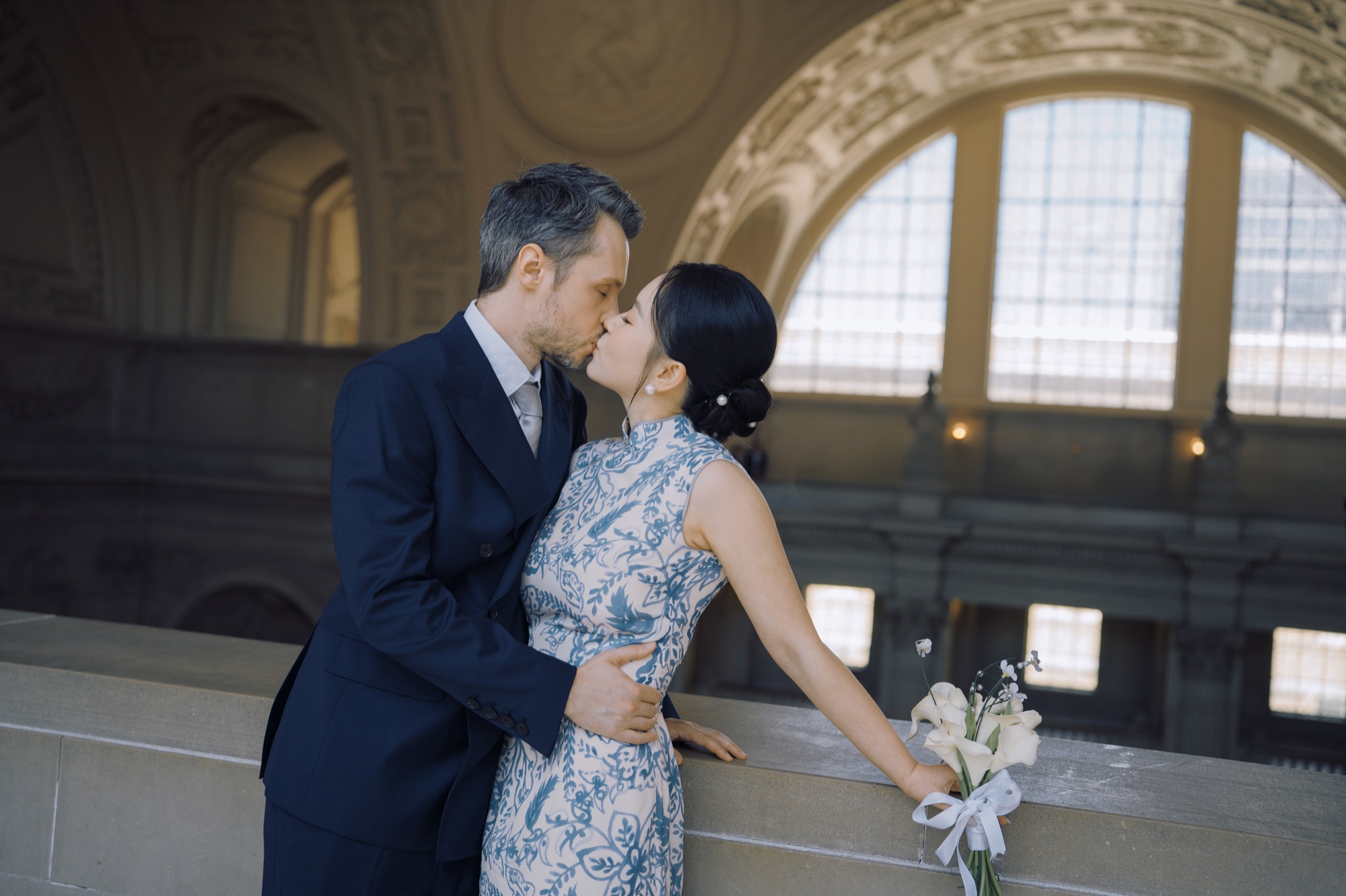The couple leaning toward one another inside City Hall