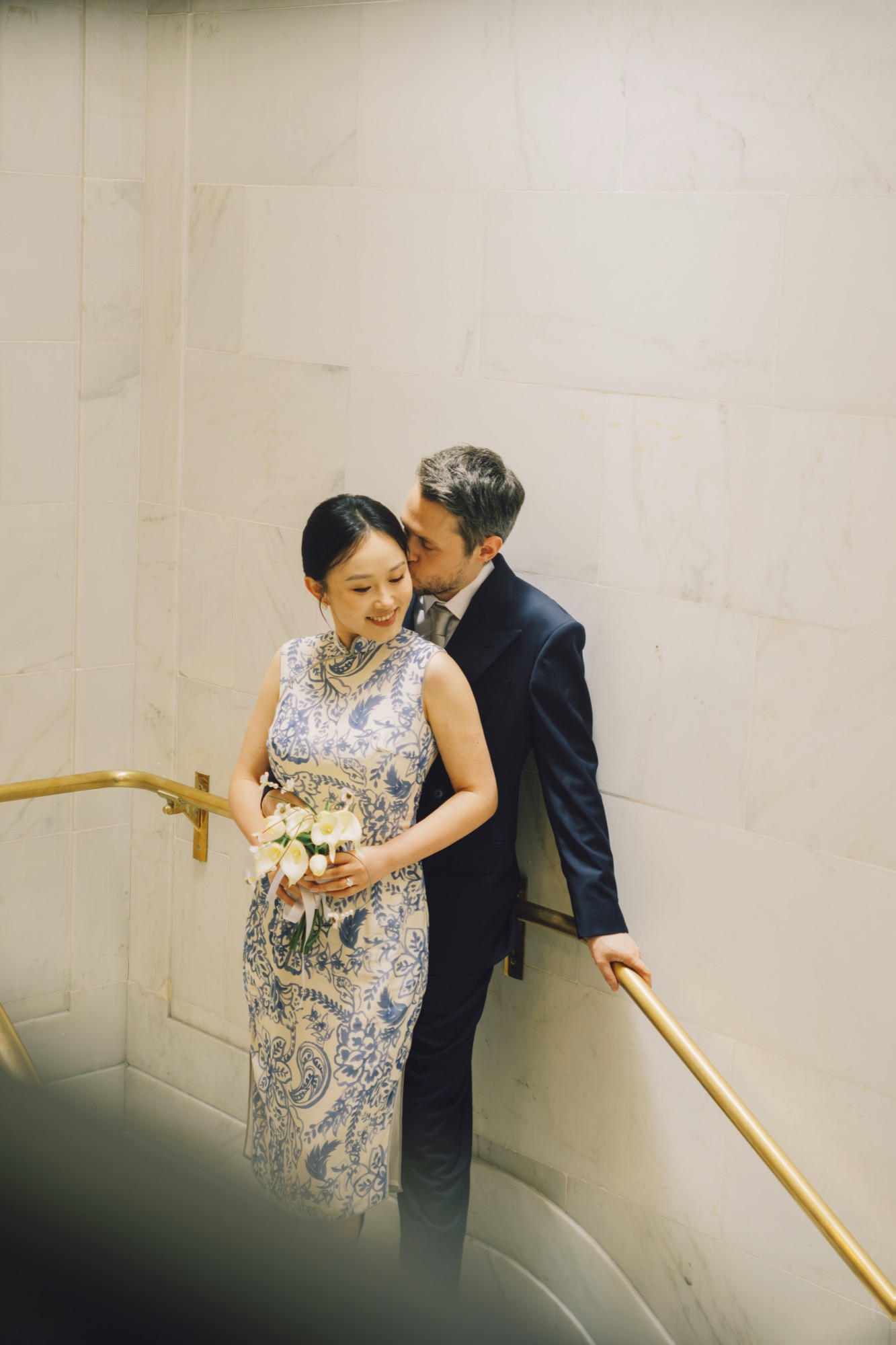 The couple walking along a City Hall staircase