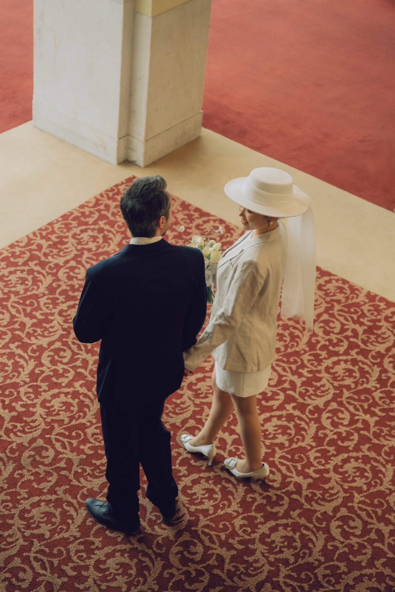 An overhead view of the couple walking through City Hall