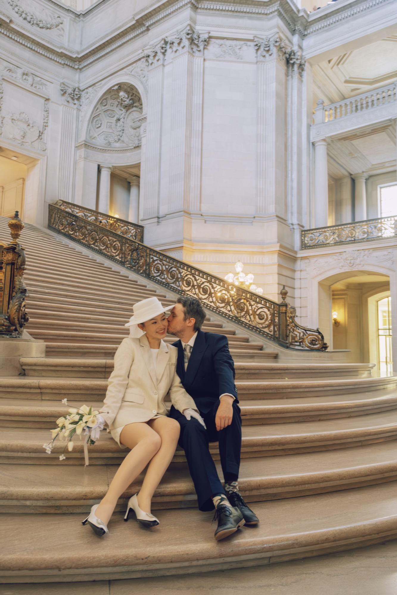 The couple seated together on the City Hall stairs