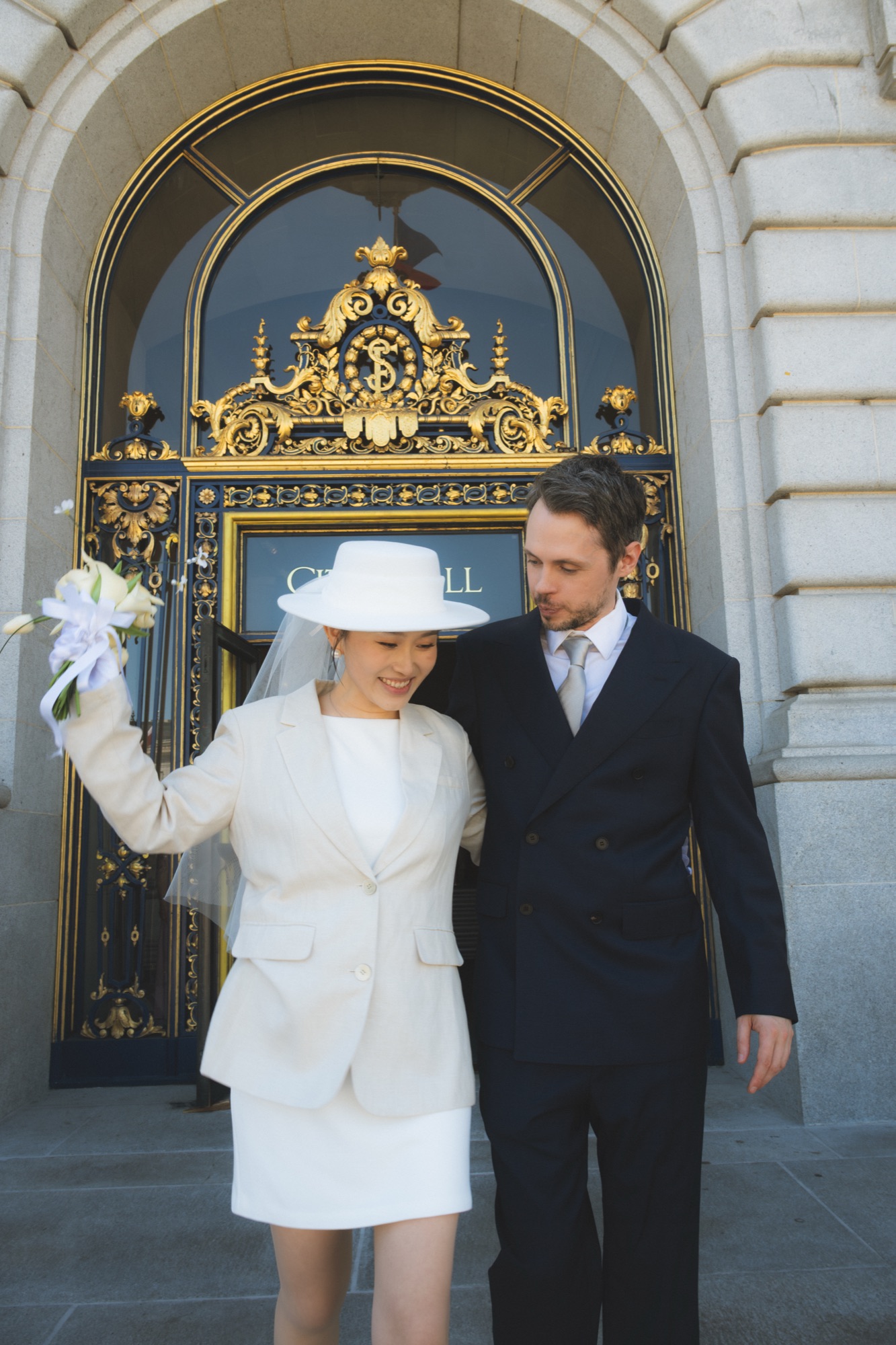 The newlyweds outside the ornate City Hall entrance