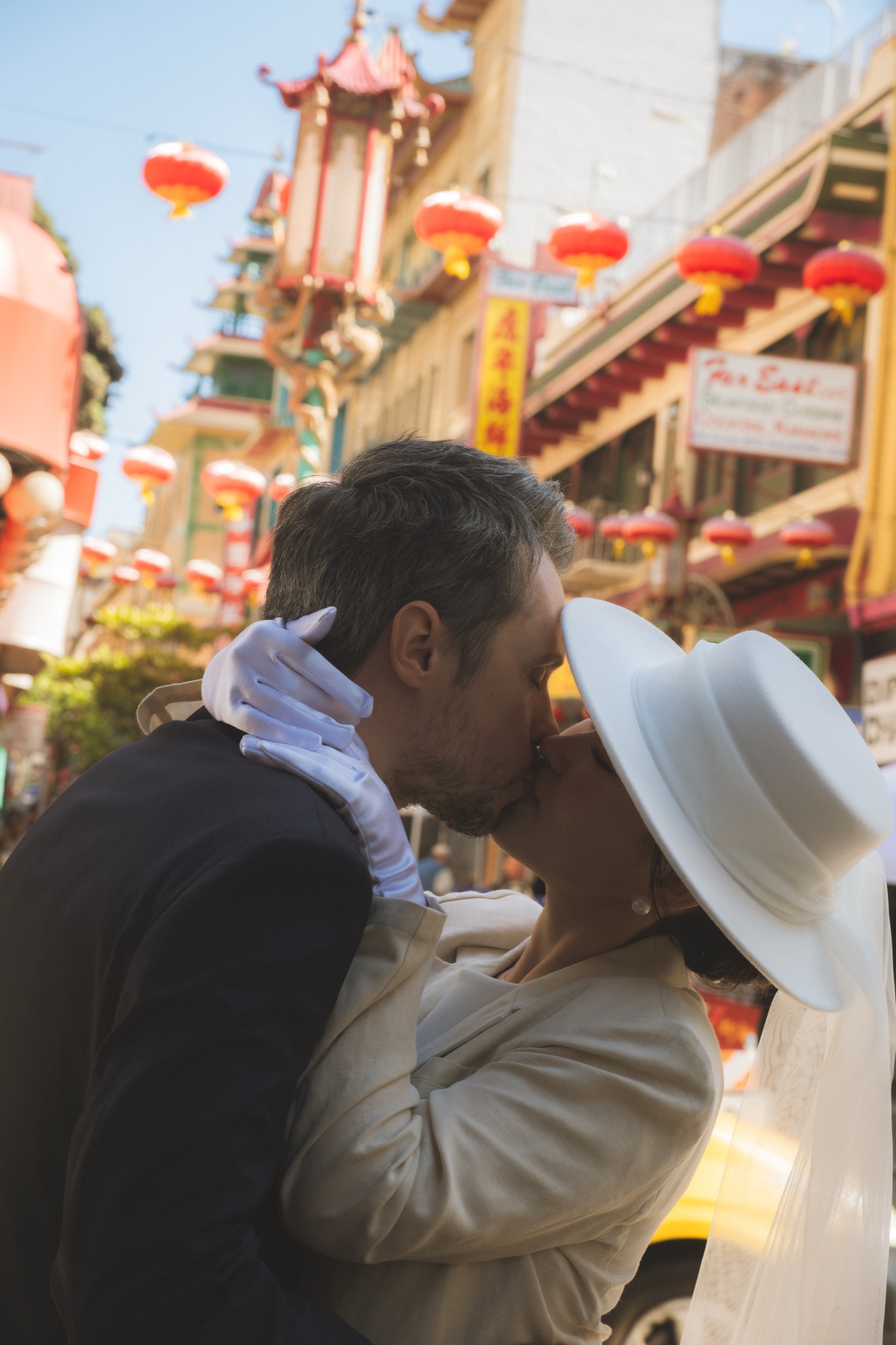 The newlyweds kissing on a Chinatown street