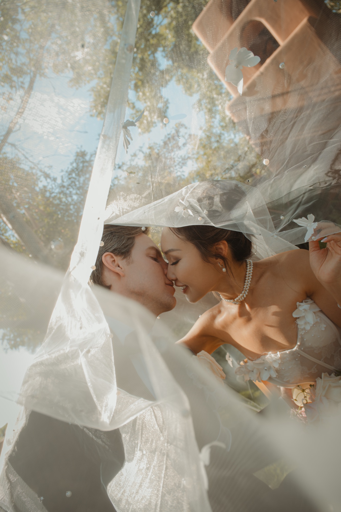 Nicole and Tanner sharing a quiet moment beneath her veil