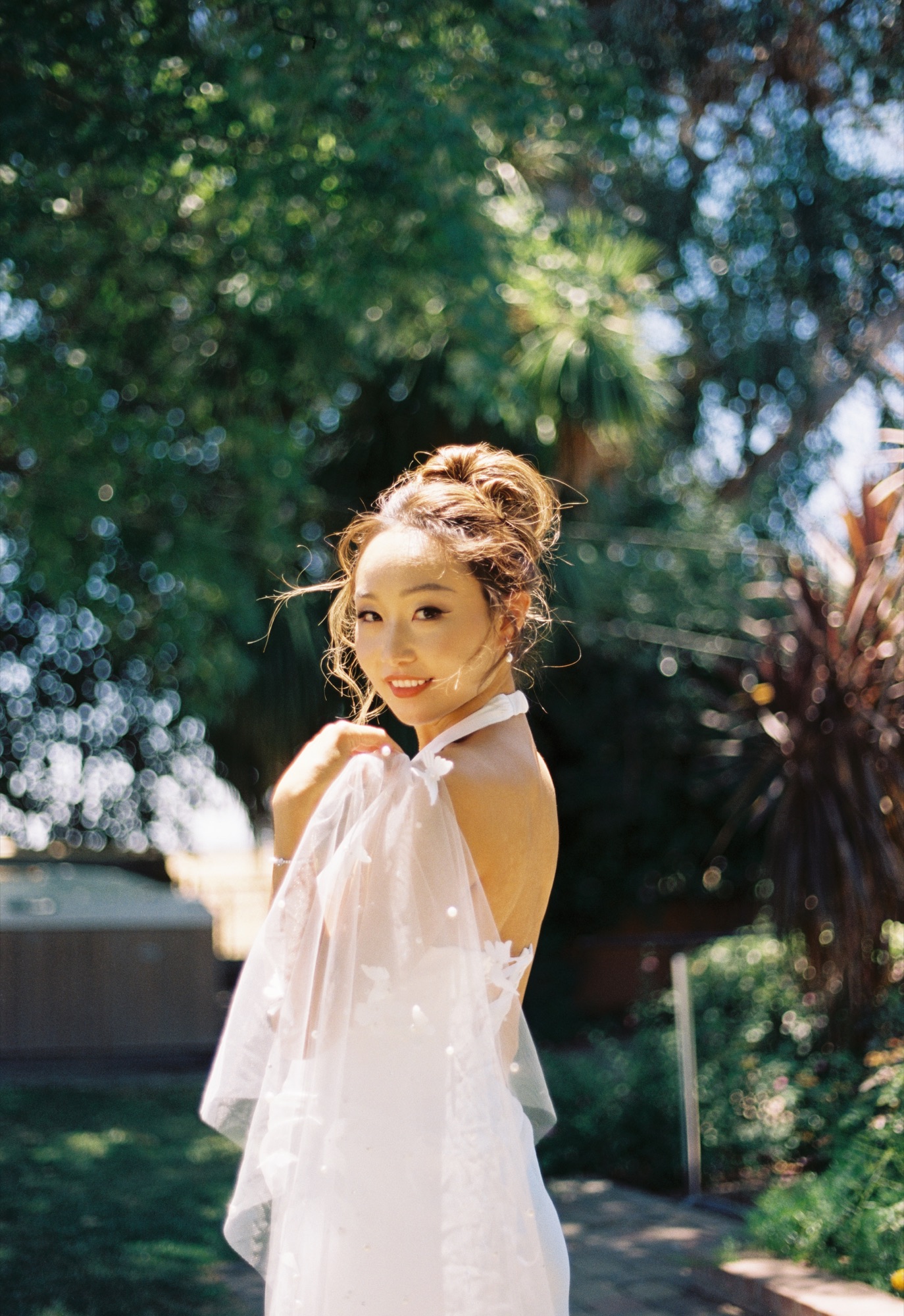 A sunlit portrait of Nicole in her wedding dress