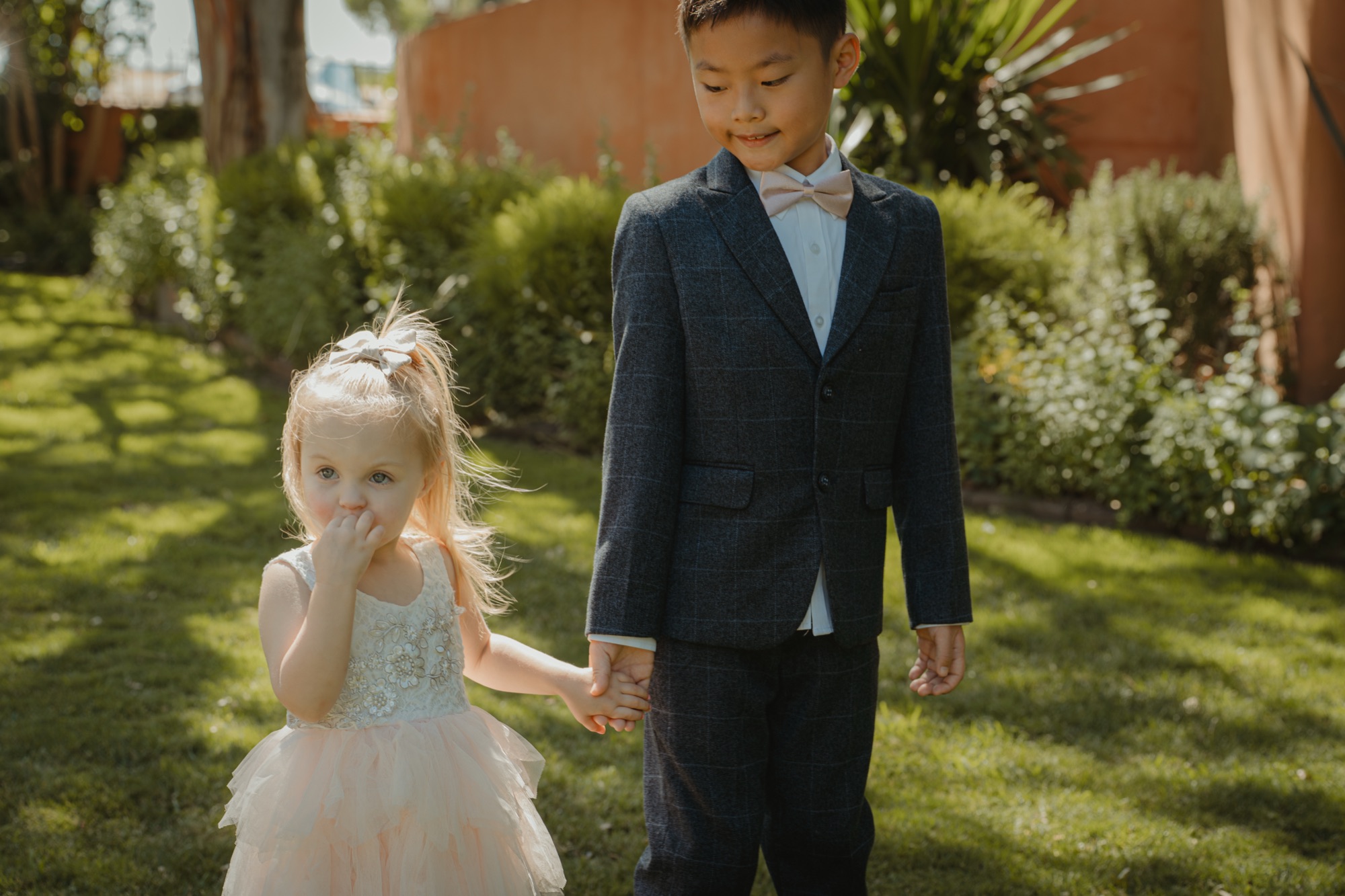 Tanner walking beside a young flower girl