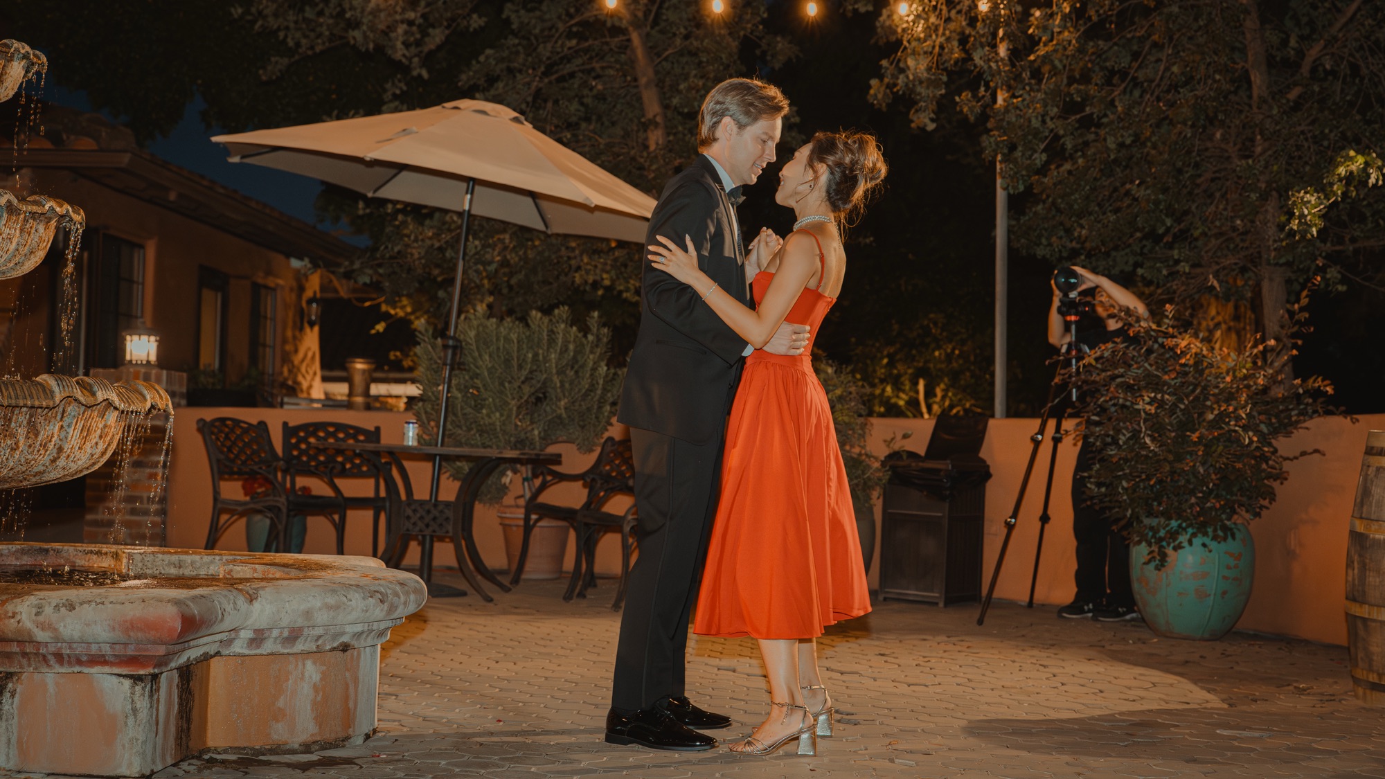 Nicole dancing in a red dress at the evening reception